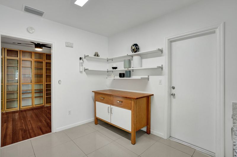 Kitchen corner with open shelving and a side door