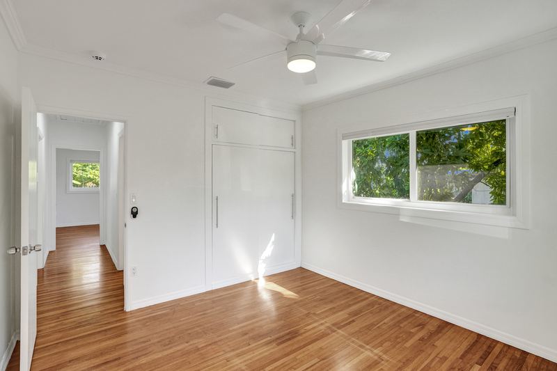 Bedroom with a built-in closet and wood floors