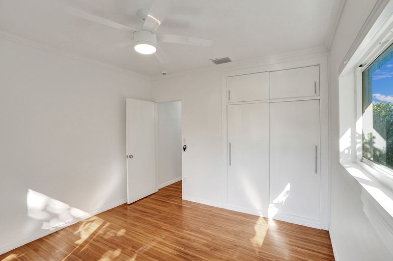 Bedroom with a built-in wardrobe and ceiling fan