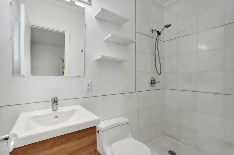 Second bathroom with a walk-in shower and floating shelves