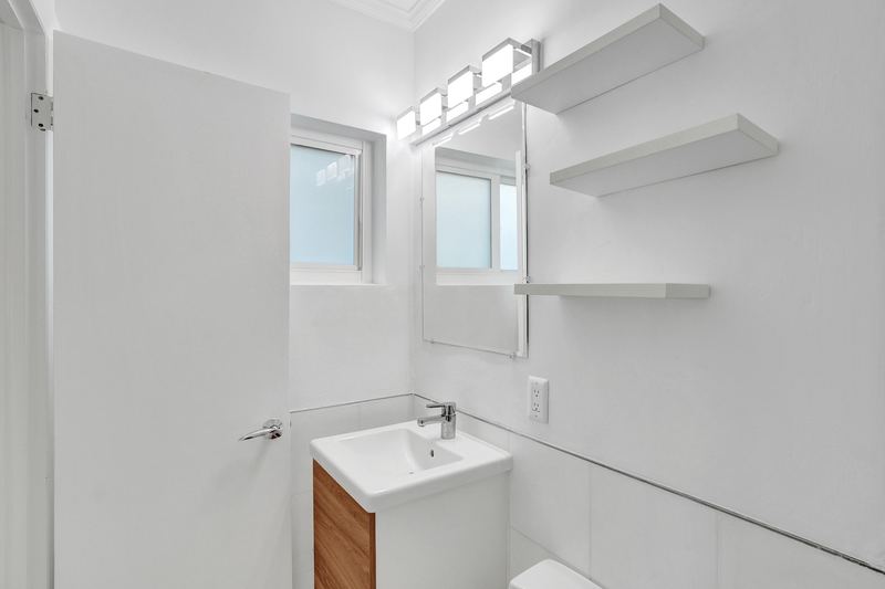 Second bathroom with a compact vanity and window
