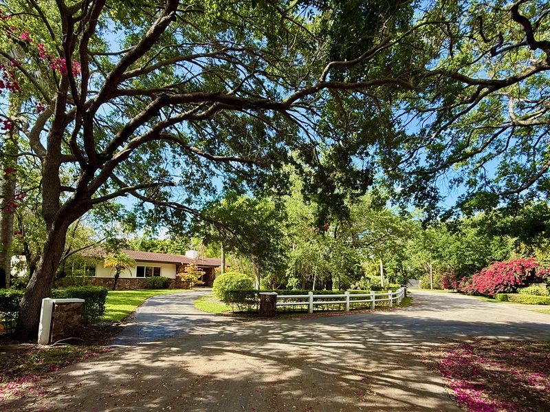 Cul-de-sac street view looking toward the driveway entrance of 7555 SW 79th Avenue, Miami