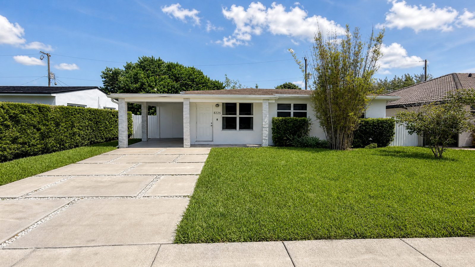 Front exterior and lawn of 8225 SW 44th Street, a renovated single-family home near Tropical Park in Miami