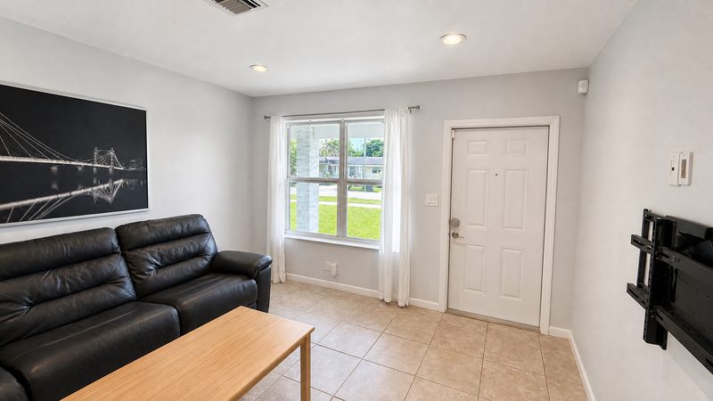 Living room with natural light and the front entry at 8225 SW 44th Street, Miami