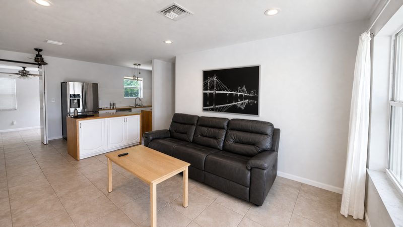 Open living space with the kitchen island and breakfast bar at 8225 SW 44th Street, Miami