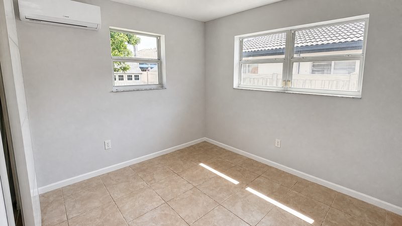 Bedroom with two windows and tile floors at 8225 SW 44th Street, Miami