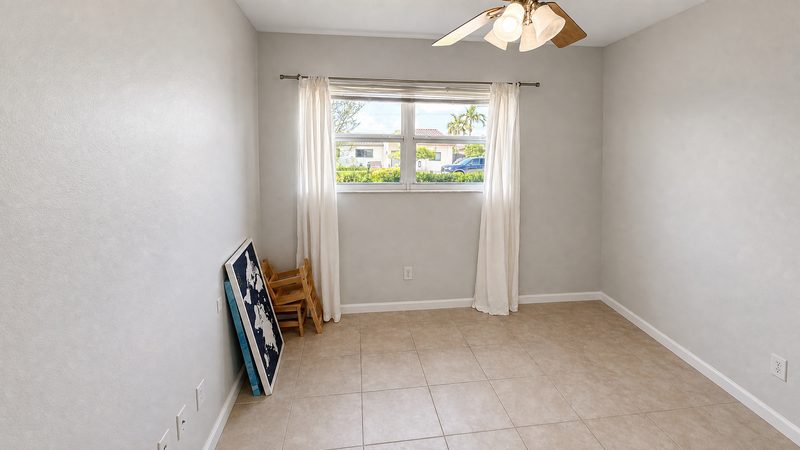 Bedroom with a window and ceiling fan at 8225 SW 44th Street, Miami
