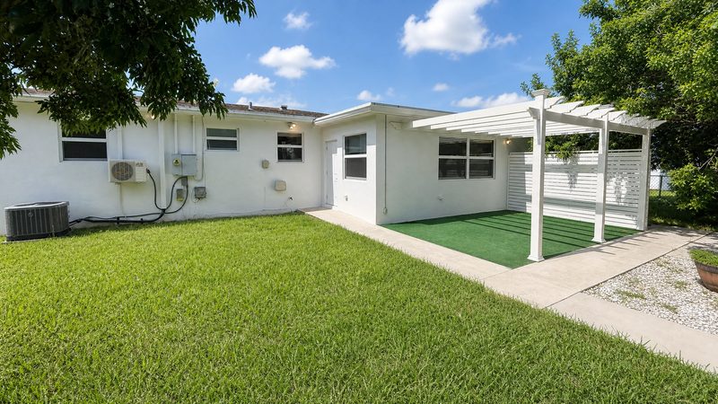 Rear exterior with covered patio and fenced yard at 8225 SW 44th Street, Miami