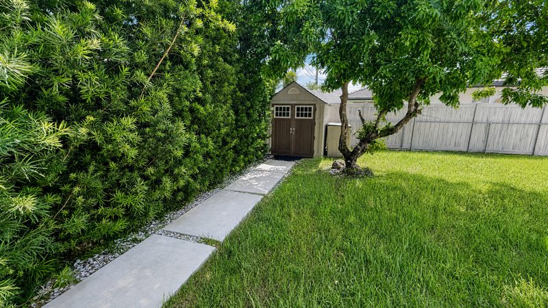 Fenced side yard with a storage shed at 8225 SW 44th Street, Miami