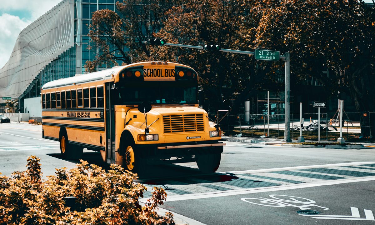 Yellow school bus at a city intersection in Miami