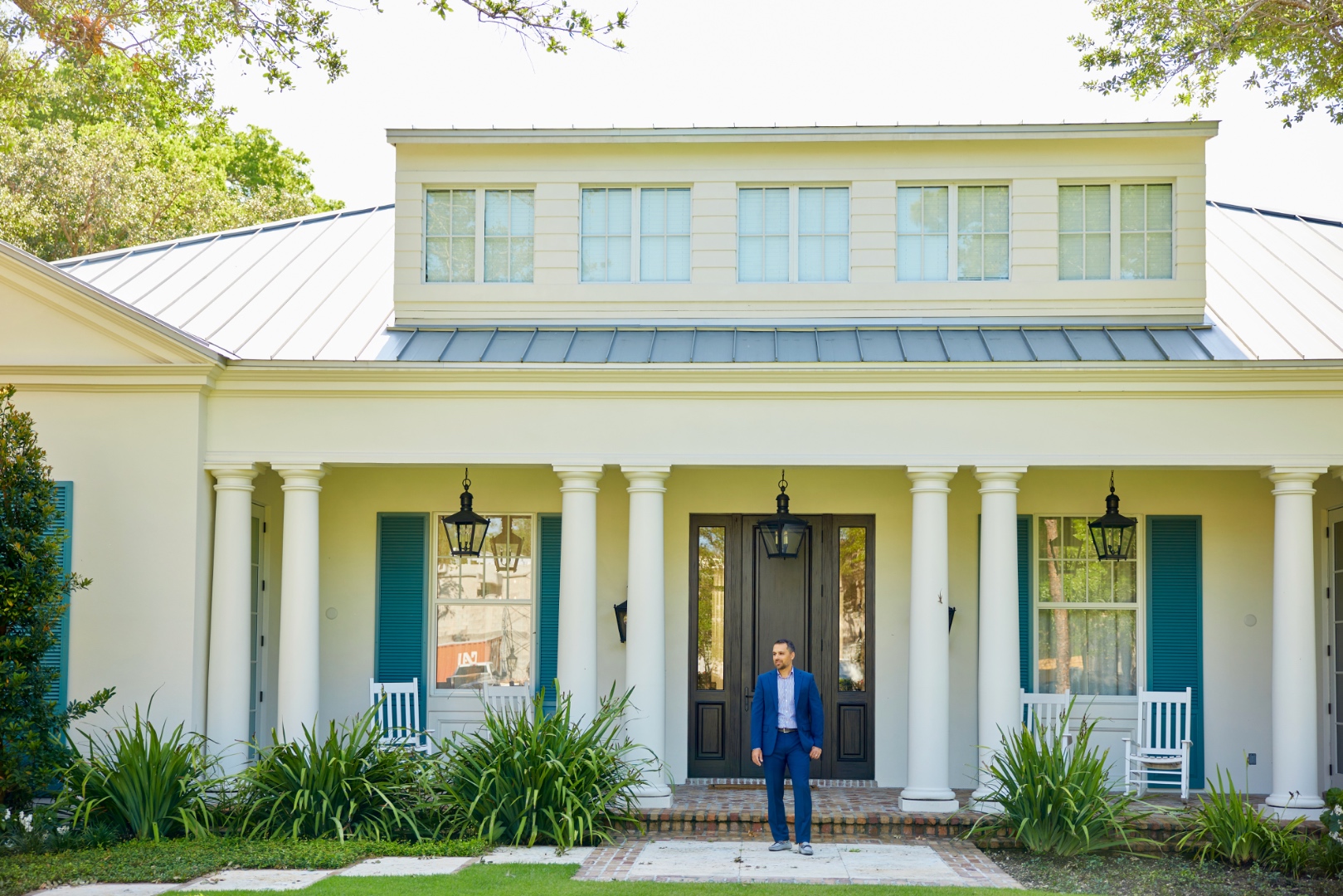 Jorge Guanche standing in front of a luxury Miami home