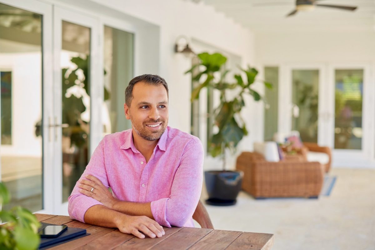 Jorge Guanche seated at an outdoor patio table